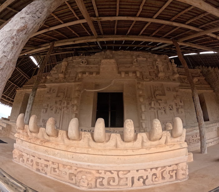 Ancient ruins of Ek Balam's fortress with intricate Mayan carvings